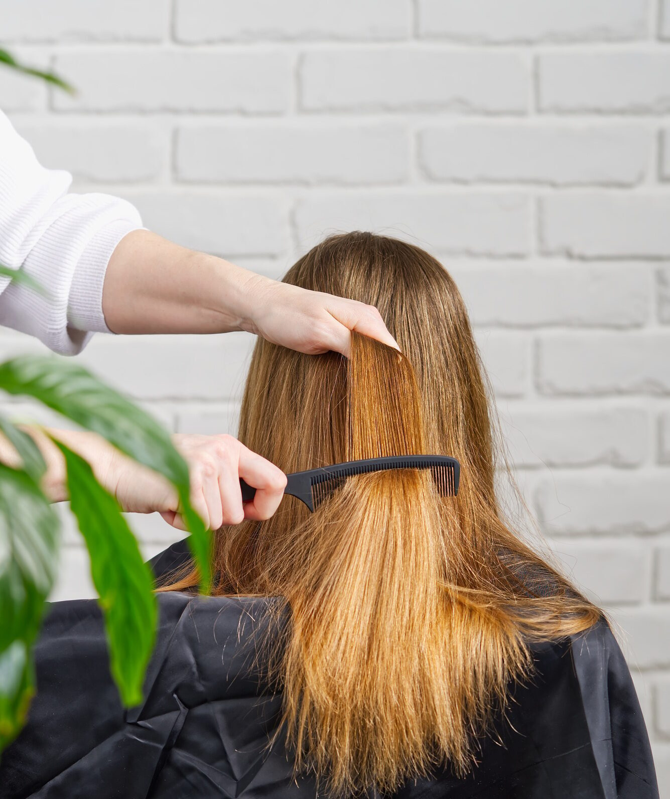 Beautiful girl with long hair. creating a hairstyle for unrecognizable girl. Hair styling process.