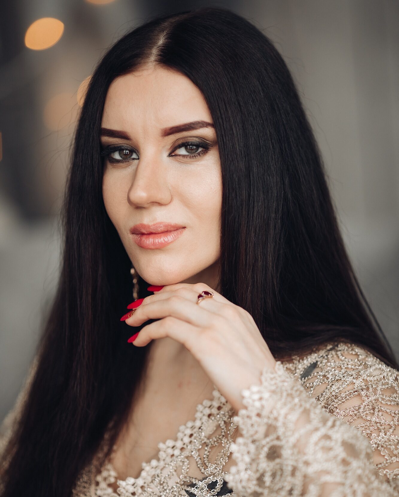 Gorgeous brunette in laced dress with make up.